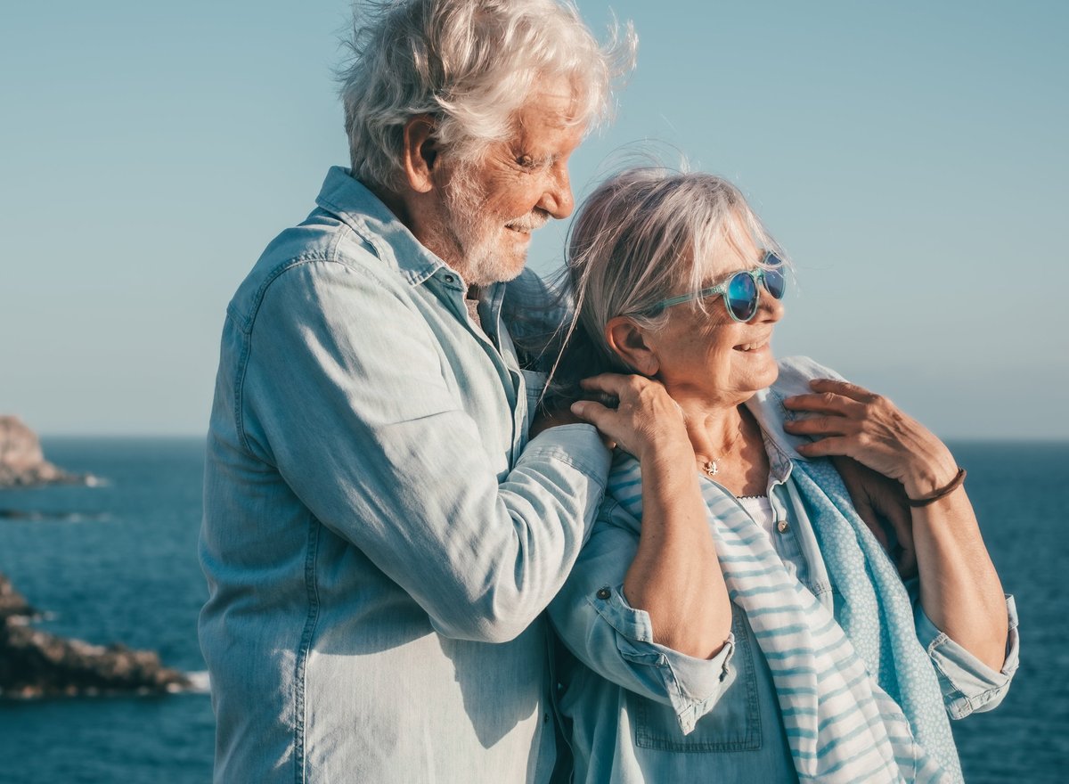 Happy senior couple enjoying retirement by the seacoast