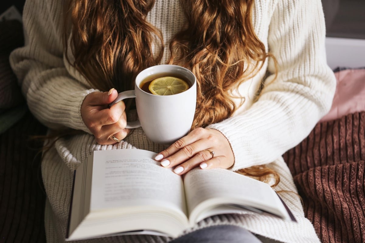 Relaxed weekend moment with warm sweater, soft blanket and peaceful atmosphere of comfort and home relaxation.