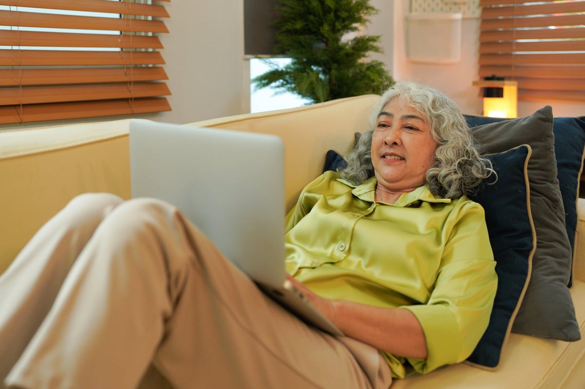 Happy retired woman accessing resources online