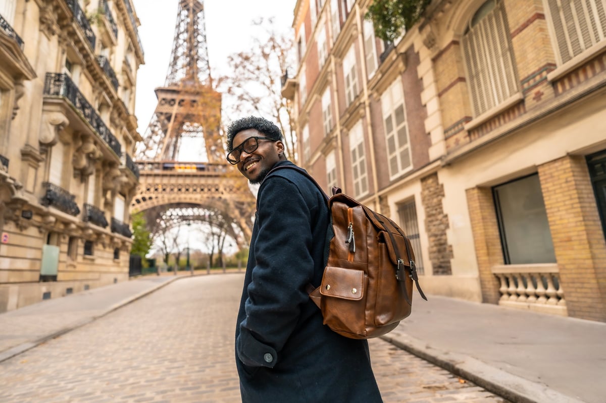 A traveler walking down a cobblestone street in a European city, enjoying the walk